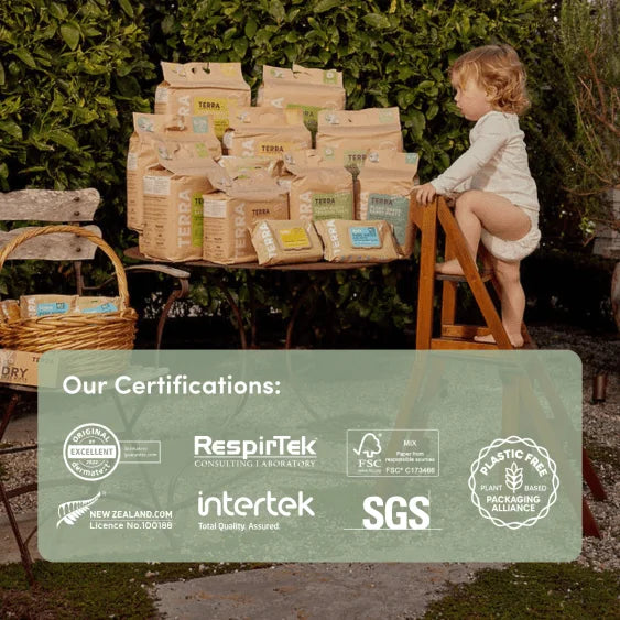 Child playing with a stack of Terra brand packages outdoors, with certification logos displayed.