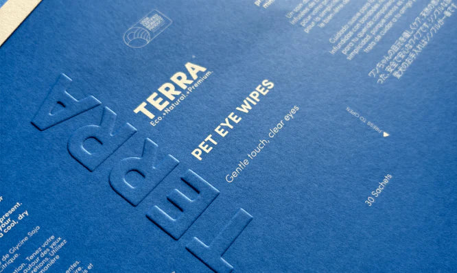 Blue packaging of TERRA pet eye wipes with embossed text.