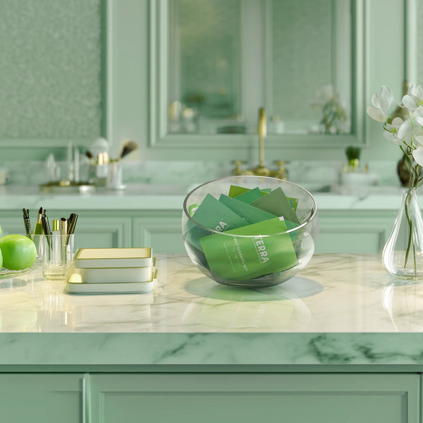 Bathroom counter with Terra wipes and a vase of white flowers.
