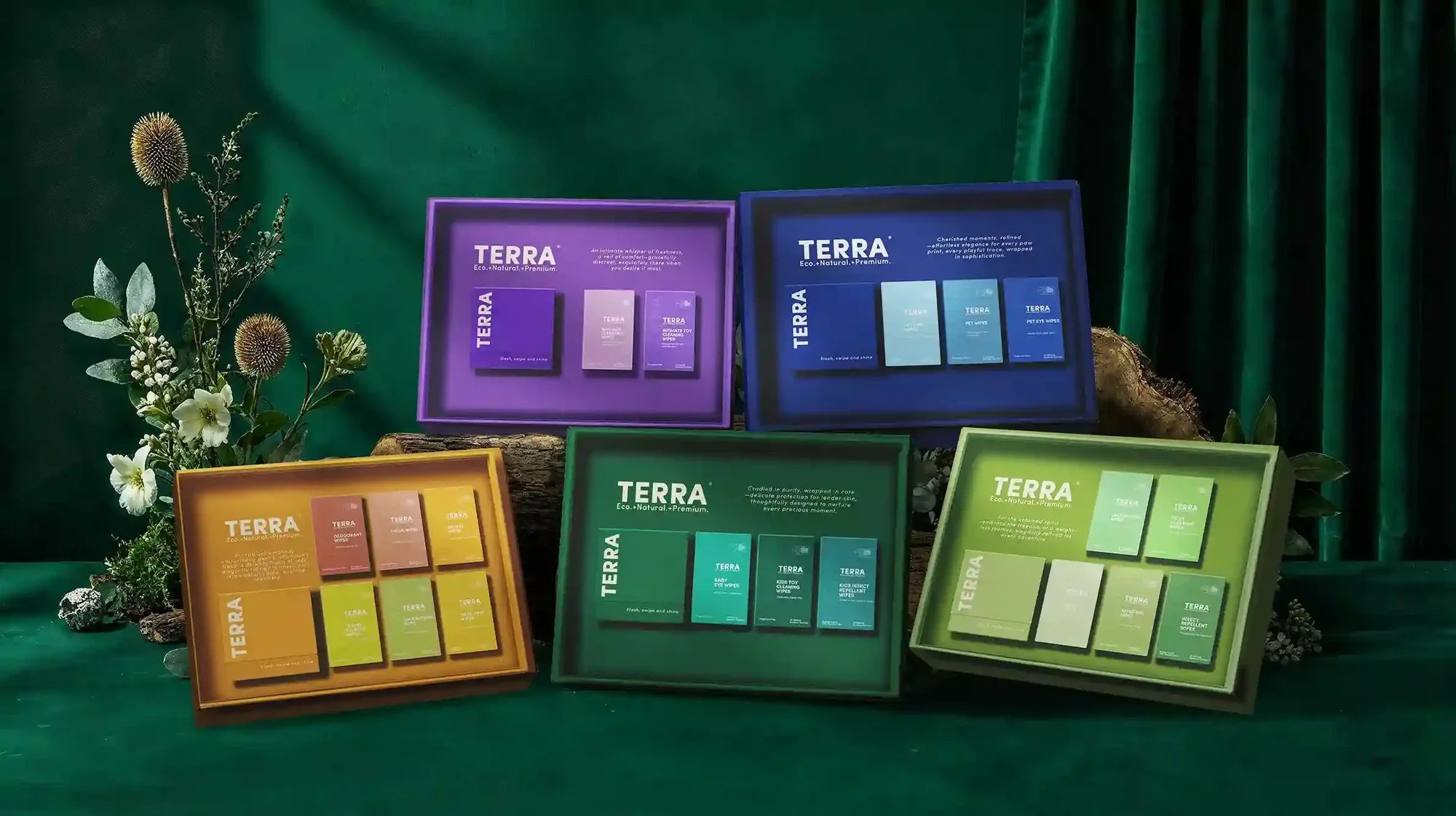 Collection of TERRA product boxes on a green background with flowers.